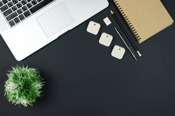 istock Business office work desk table with computer laptop , note and stationery on black table background include copyspace for add text or graphic 867213642