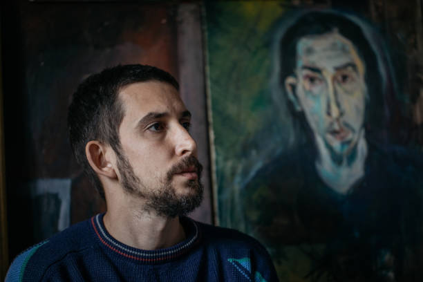 istock Artist next to his paintings 867213648