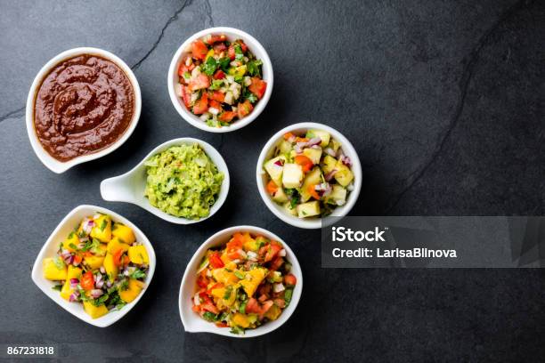 Traditional Famous Mexican Sauces Chocolate Chili Mole Poblano Pico De Gallo Avocado Guacamole Salsa Bandera Pinapple Salsa Mango Salsa On Slate Gray Background Stock Photo - Download Image Now