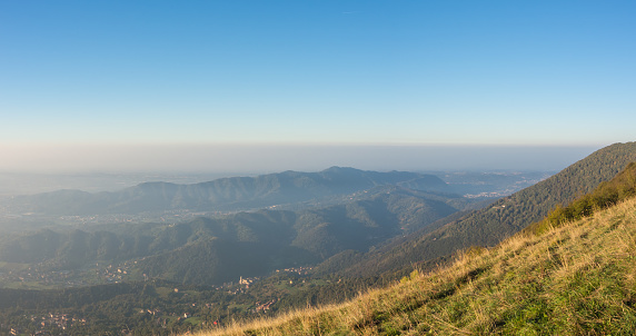 Morning landscape on the Padana plain with high pollution and humidity in the air. Panorama from Linzone Mountain, Bergamo, Italy