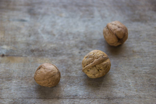 istock Walnuts on wooden table. Whole fresh walnuts 867248260