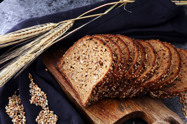 istock Sliced rye bread on cutting board. Whole grain rye bread with seeds. 867264638
