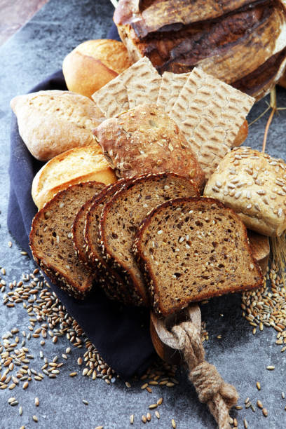 istock Sliced rye bread on cutting board. Whole grain rye bread with seeds. 867264696