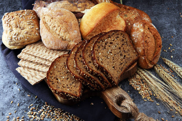 istock Sliced rye bread on cutting board. Whole grain rye bread with seeds. 867265496