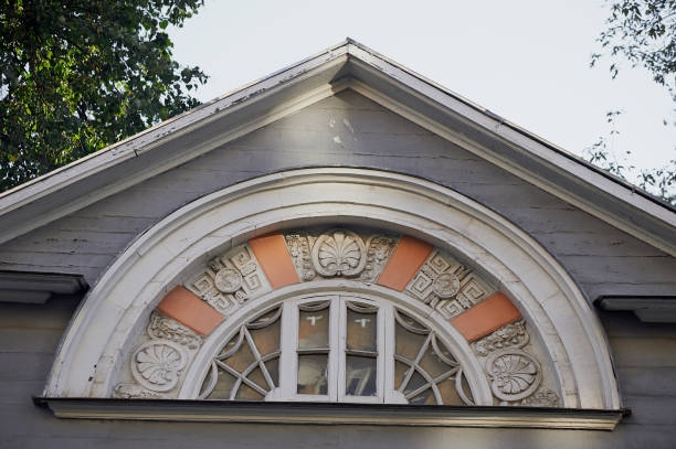 Old rounded window in the old wooden house.Architecture