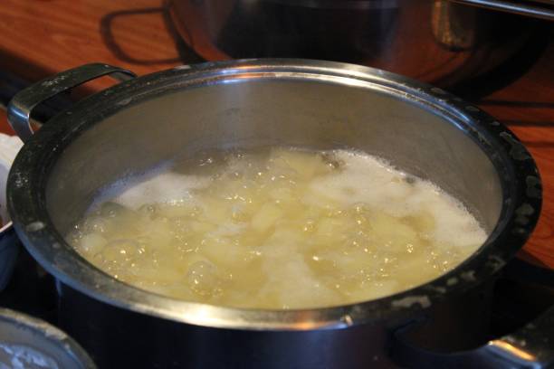 istock Potato in hot water. 867284008