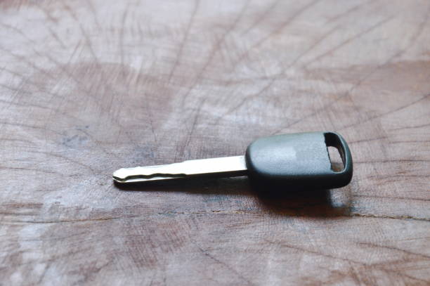 car key on wooden table black car key on wooden table car keys table stock pictures, royalty-free photos & images