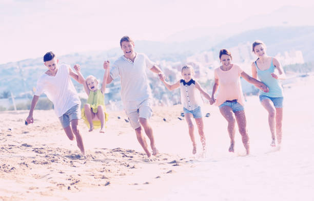 istock Big family running on beach 867287898