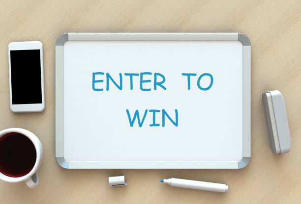 istock Enter to Win, message on whiteboard, smart phone and coffee on table, 3D rendering 867293830