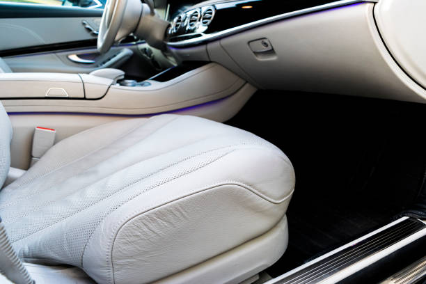 istock White leather interior of the luxury modern car. Leather comfortable white seats and multimedia. Steering wheel and dashboard. Automatic gear shift. Car interior details 867294832