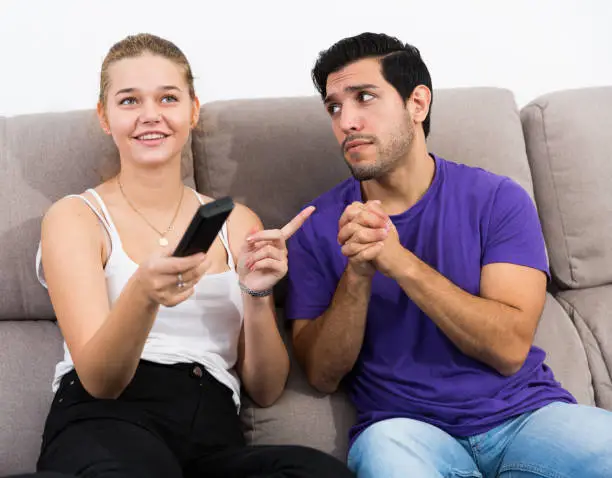 Photo of Guy begging girlfriend for TV remote