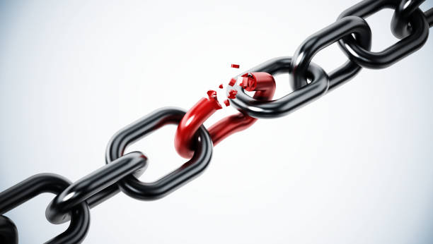 Broken red chain part among metal parts