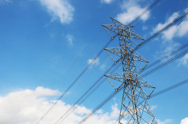 High voltage tower or Electric transmission line with blue sky and white cloud for Background or Backdrop.