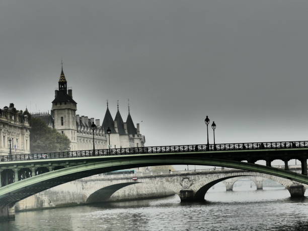 Paris bridges under the mist ant the conciergerie