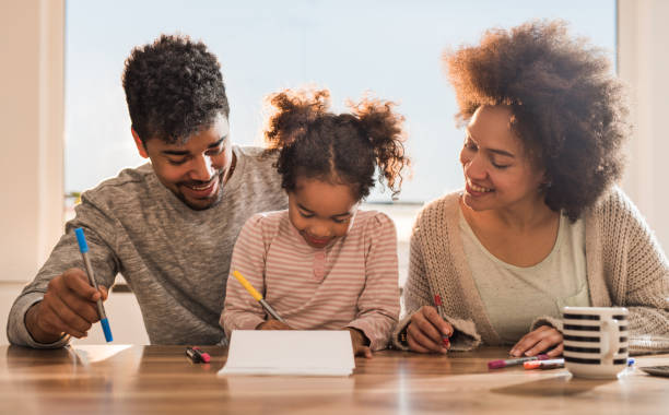 istock Creative black family drawing and having fun together at home. 867323186