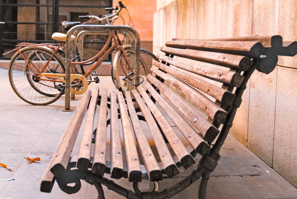 Perspective view of bicycles parked next to a wooden bench