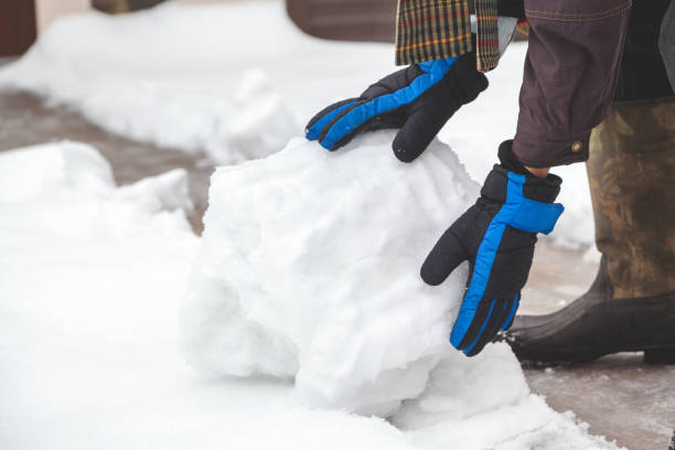 istock Hands in gloves rolled snowball 867334160
