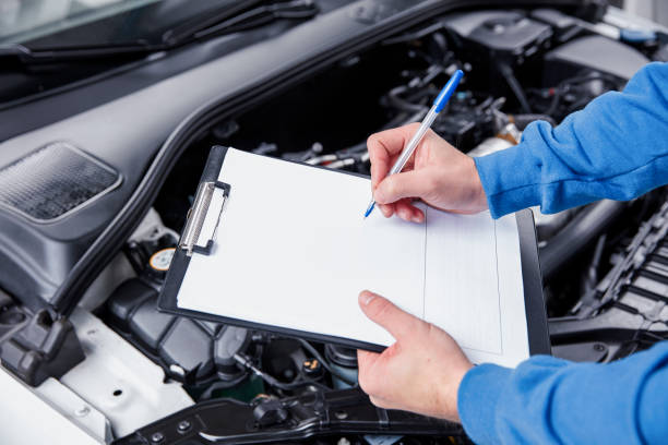 istock Auto mechanic working on a car engine in repair shop. 867337480