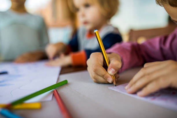 istock Close up of unrecognizable child drawing with colored pencil. 867338114