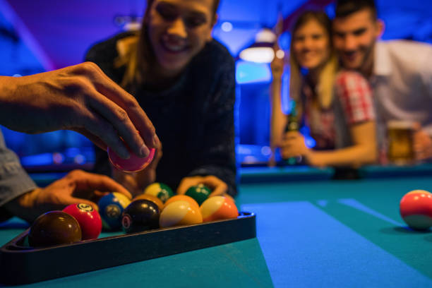 istock Close up of man arranging pool balls in triangle shape. 867338488