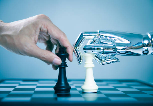 Robotic playing chess with human Robotic playing chess with human computer chess stock pictures, royalty-free photos & images