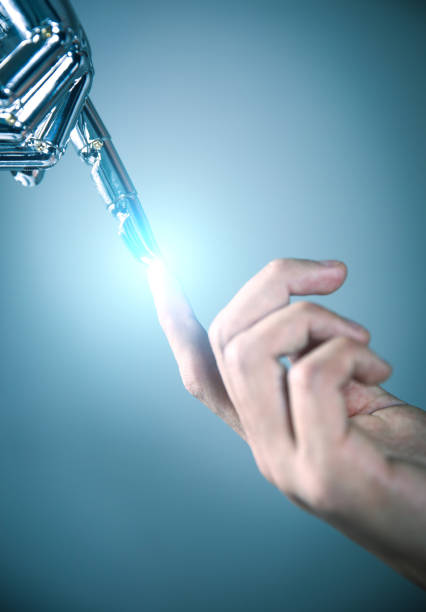 istock Robotic and human hands reaching to each other 867341650