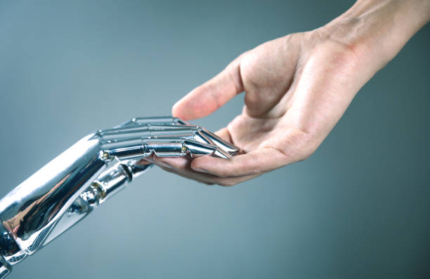 istock Robotic and human hands reaching to each other 867341690