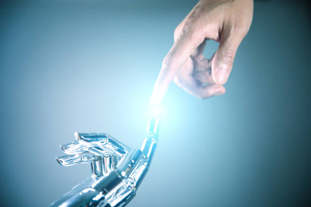istock Robotic and human hands reaching to each other 867341772