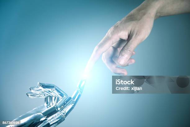 Human And Robot Hand Connecting Stock Photo - Download Image Now - People, Robot, Cyborg