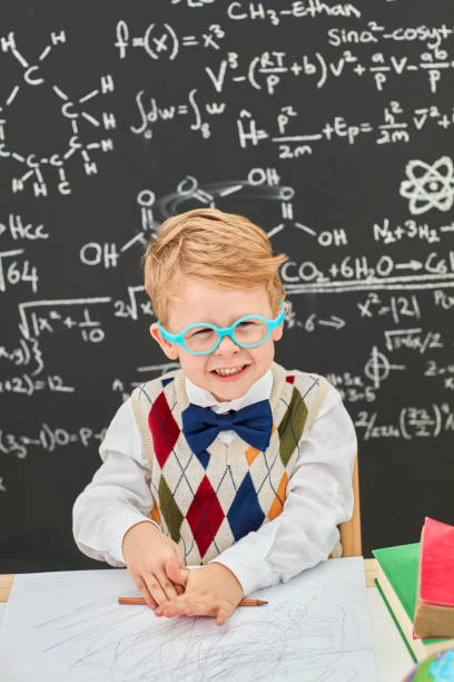 istock Smart boy in front of black board 867342276