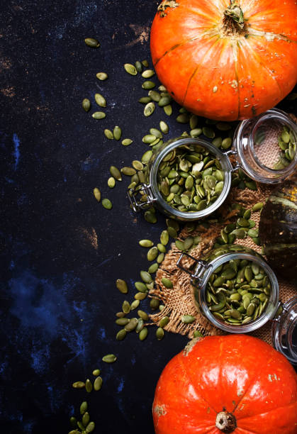 istock Raw pumpkin seeds in glass jar 867342440