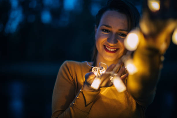istock Woman with light bulbs outdoors 867345760