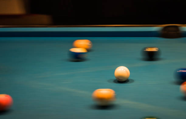 istock Group of multi-colored pool balls on a table in blurred motion. 867348256