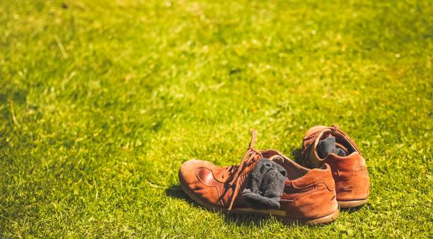 istock Two shoes and socks on the grass 867348544