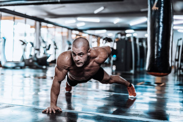 istock Man exercising and doing push-ups in the local gym 867348746