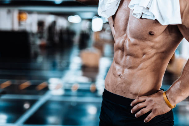 Young man tired after training showing his abdominal muscles stock photo