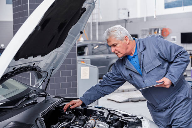istock Auto mechanic working on a car engine in repair shop. 867351606