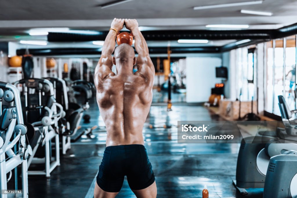 Man Exercizing Man Exercising With Kettlebell In The Gym Stock Photo - Download Image ...