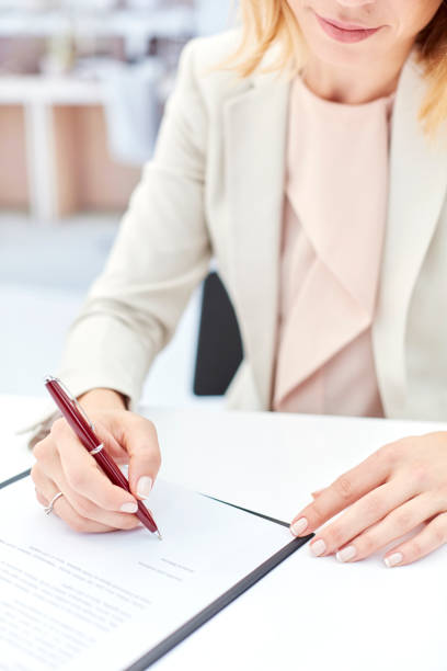 istock Business woman signing a document. 867352126