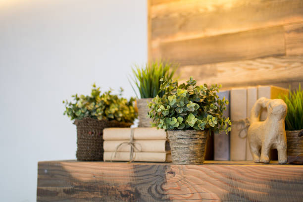 istock Artificial flowers and book on a wooden shelf. 867353082