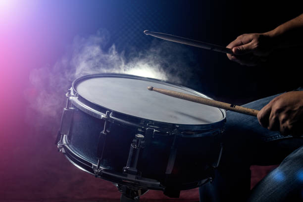istock The man is playing snare drum in low light background. 867353228