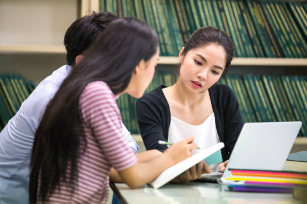 istock Group of Student Seaching information in the library together. People with Education concept. 867355960