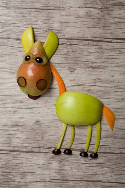 istock Horse made with apple and pear on wooden background 867356400