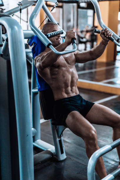 istock Young man exercising in the fym 867357192