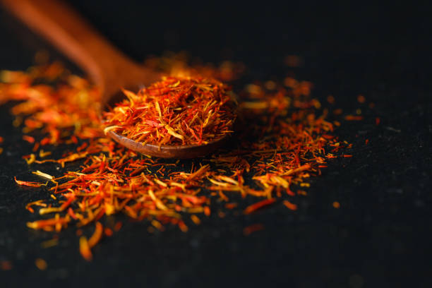 istock Saffron in a spoon on a dark background, selective focus, macro shot, shallow depth of field 867357344