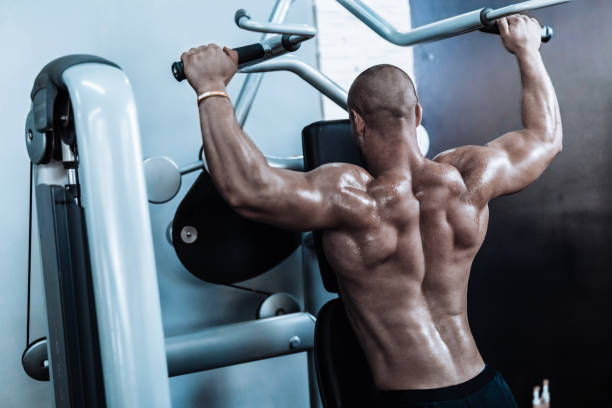 istock Young man exercising in the fym 867359386