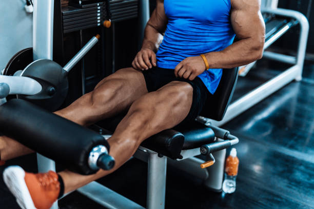 istock Young man exercising legs in the local gym 867359616