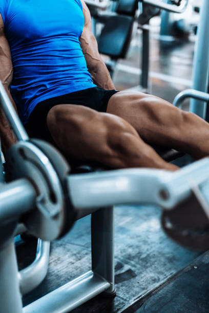 istock Young man exercising legs in the local gym 867359746