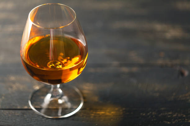 istock Glass of brandy on black background 867360334