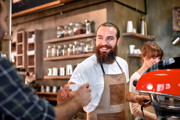 istock Staff Serving Customer In Busy Coffee Shop 867362846